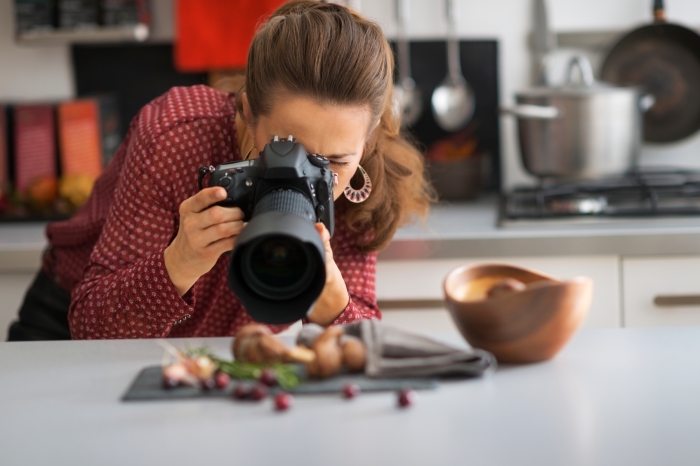 Young woman photographing food